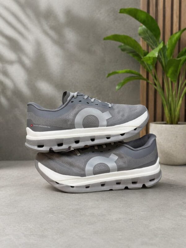 Grey running shoes on display.